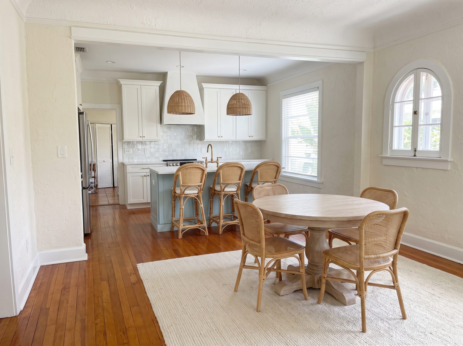 Renovation concept: dining room opened to a new white and sea-glass kitchen